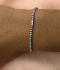 Minimal silver 2mm stainless steel tennis bracelet worn on wrist with clear zircon stones waterproof Lemonberry Aurora