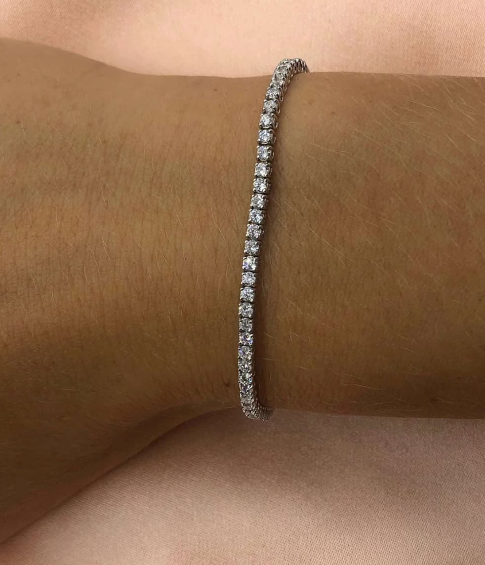 Minimal silver 2mm stainless steel tennis bracelet worn on wrist with clear zircon stones waterproof Lemonberry Aurora