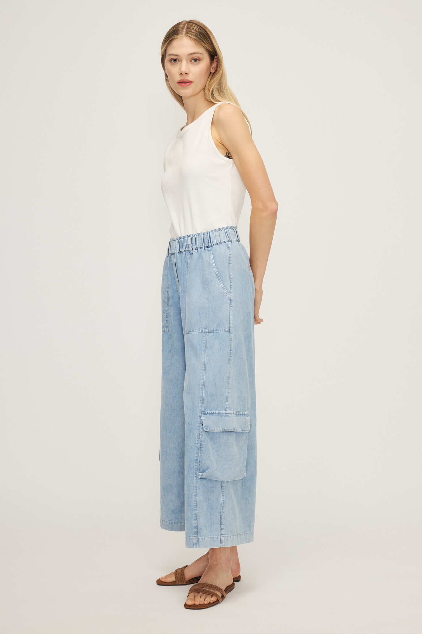 Model wearing Melissa Nepton's Silvestre wideleg cargo pant, paired with a white tank and brown sandals.