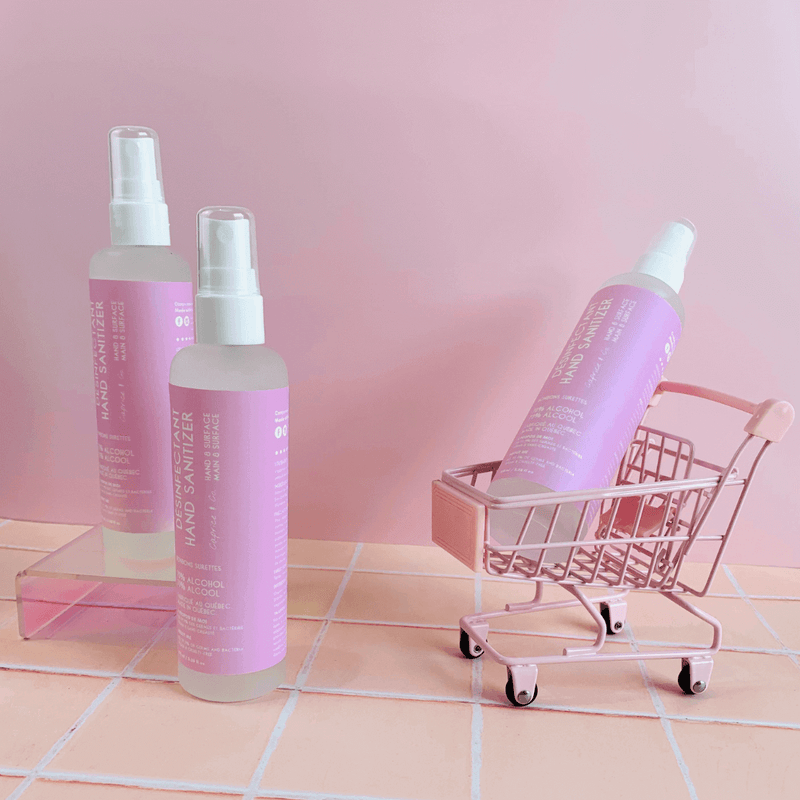 Sour Candy sanitizer styled in a tiny pink shopping cart for fun, boutique feel