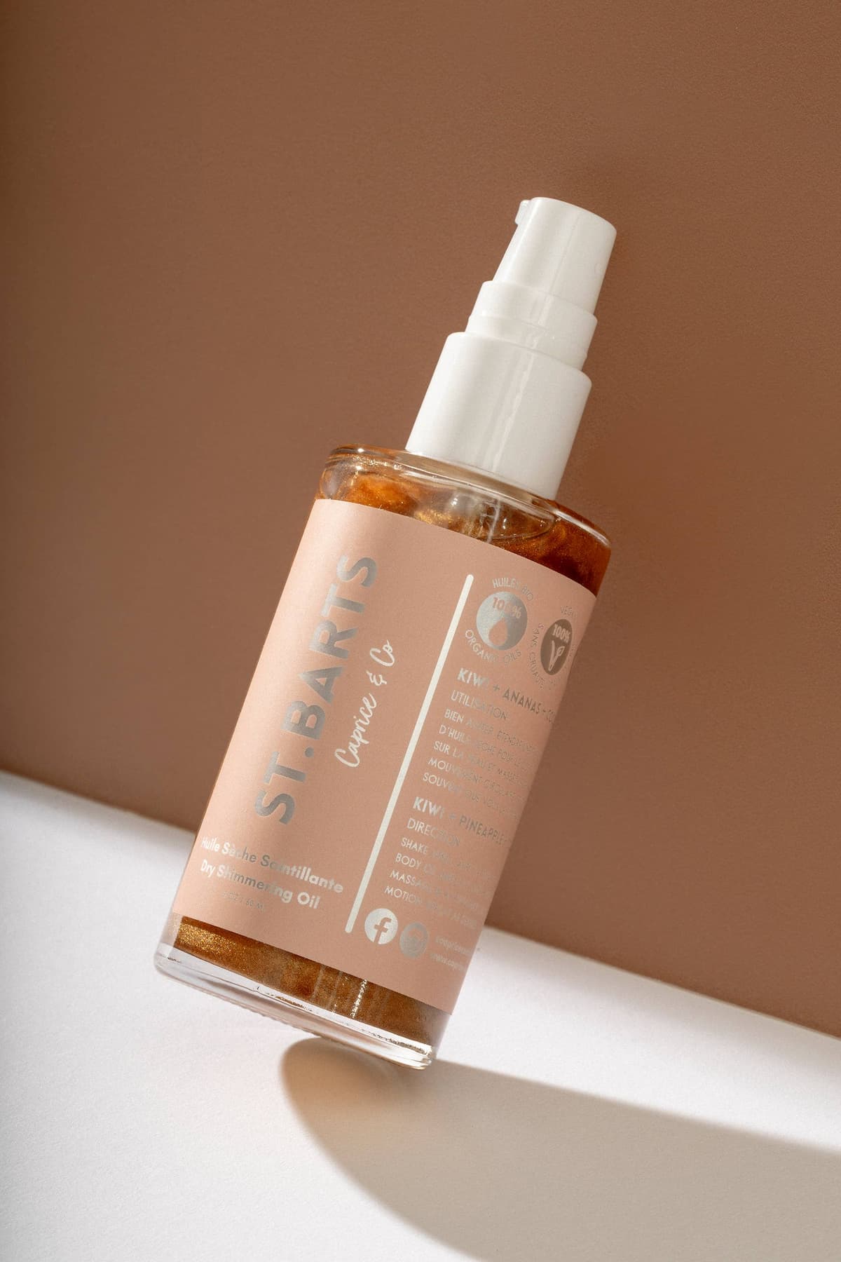 Full bottle of St. Barts dry shimmering oil in bronze with pump applicator.