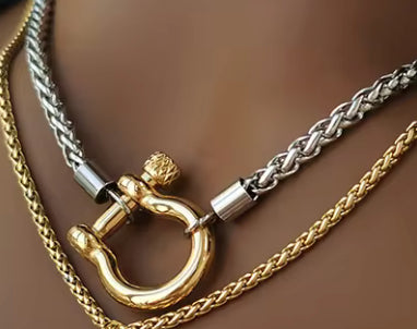 Close up of two tone stainless steel carabiner necklace layered with gold chains Lemonberry Aurora