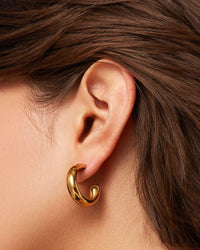 Gold Jenny Bird Staple Hoops medium size — worn on model ear, Lemonberry Aurora display