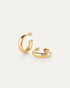 Staple Hoops Medium Earrings in gold resting on white table by Jenny Bird at Lemonberry in Aurora.