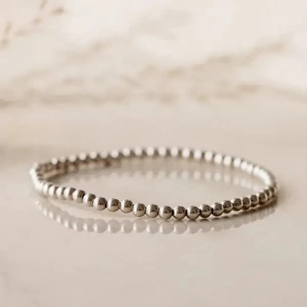Sterling silver beaded bracelet on reflective surface — photographed at Lemonberry in Aurora, ON