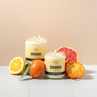 Sunshine Candle by Market Candle Company, displayed beside some citrus fruit.