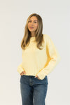 Side angle of the Lemon Drop TIMMY sweater showing relaxed fit and vibrant yellow tone.