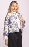 Close-up of the Toulon Jacket by Pink Martini, highlighting collarless neckline and scenic print design