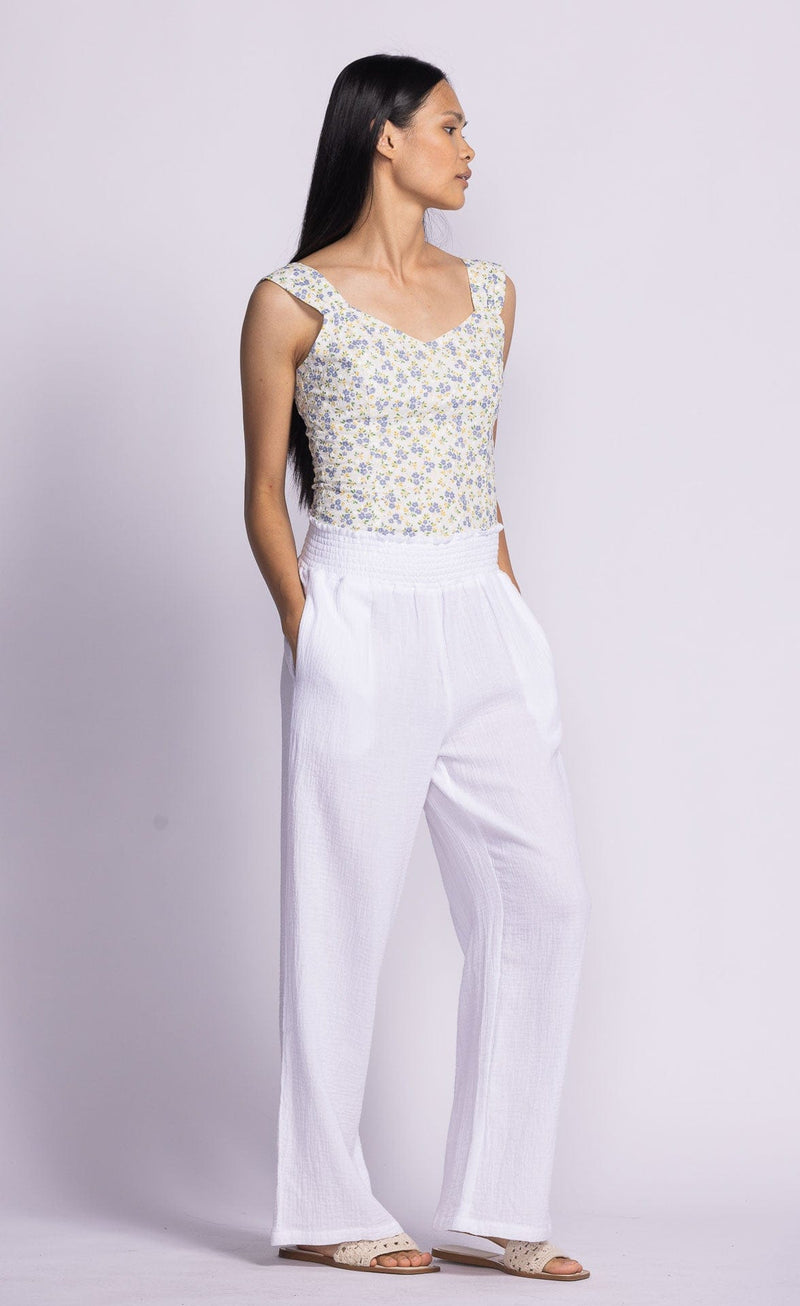 Angled view of white Vail Pants by Pink Martini, featuring a soft, breathable fabric.