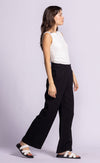 Side view of black Vail Pants by Pink Martini, showcasing the soft, breathable cotton fabric.