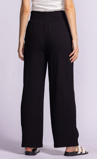 Back view of black Vail Pants by Pink Martini with an elastic waistband and relaxed silhouette.