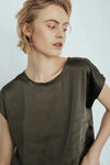 Woman wearing Melissa Nepton's Willow Tee in Khaki against a plain background