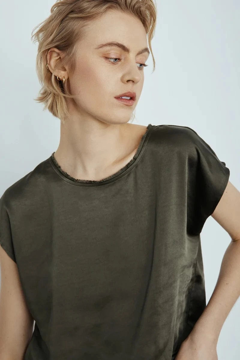 Woman wearing Melissa Nepton's Willow Tee in Khaki against a plain background