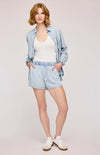 Wyatt Shorts in soft blue Sky – front view on a model with elastic waist and pockets, paired with a white tank and blue button up shirt, also by Gentle Fawn, available at Lemonberry Aurora.