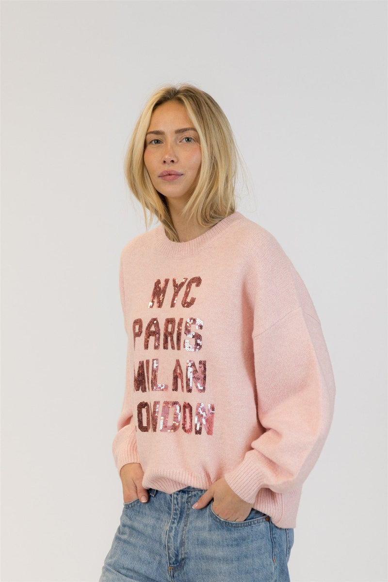 Side view of model in pink Yassie crewneck pullover by Lyla + Luxe, hands in pockets