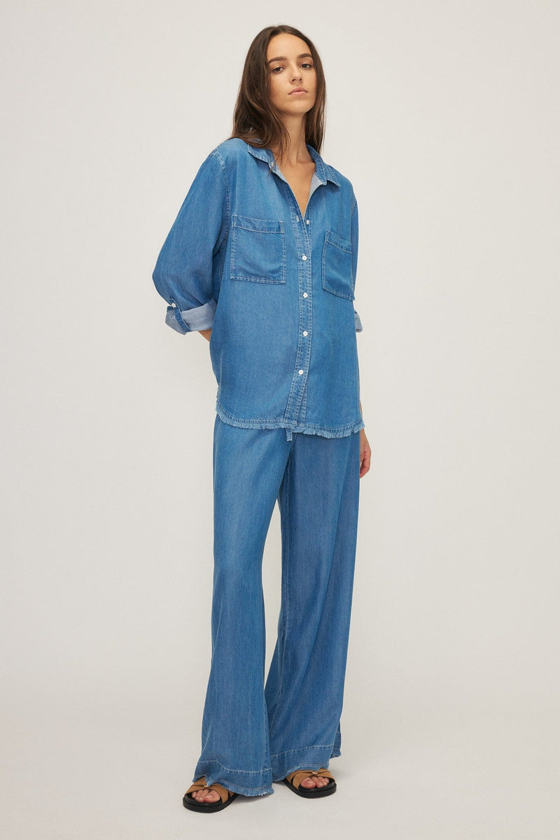 Model wearing the Yoko blouse by Melissa Nepton in medium blue, showing the relaxed flowing fit, available at our store in Aurora, or easily shipped across Canada.