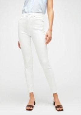 Front view of the 7FAM white high waisted skinny, paired with brown slides.