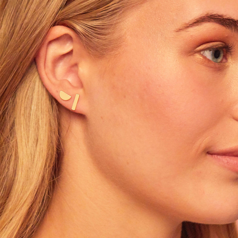 Model wearing both the gold bar and half moon stud earrings from the Geo Stud pack from Foxy Originals, available at Lemonberry, also known as Lemon Berry.